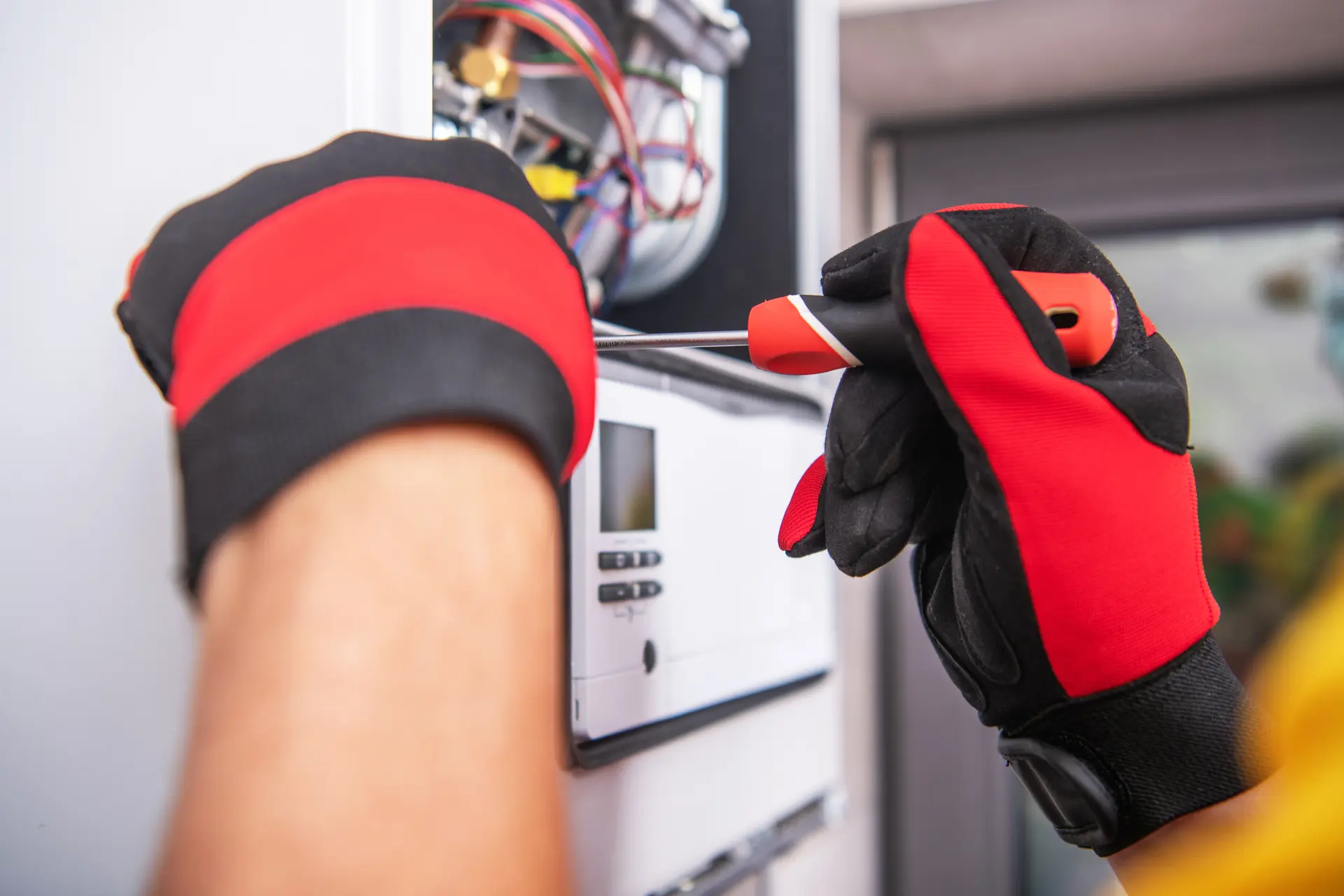Boiler repair engineer diagnosing a fault in West London