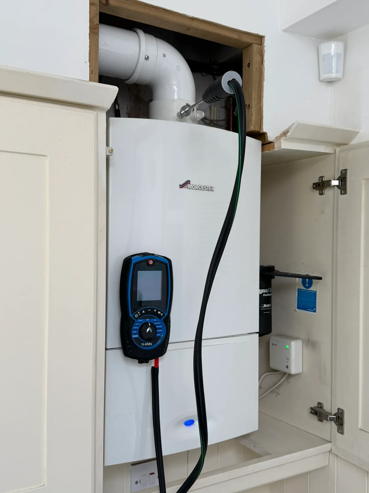 Flue gas analyser testing a Worcester boiler during a service